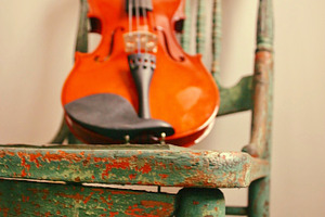 Fiddle on chair containing fiddle, violin, and rustic