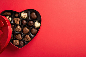 Heart-Shaped Chocolate Box on Red Background, a Food & Drink Photo by Davizro's Market