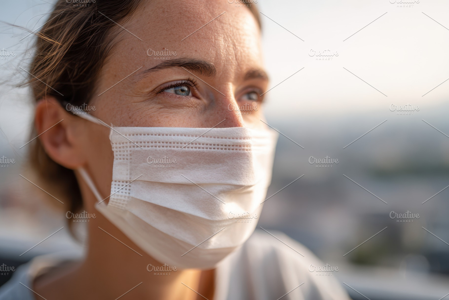 Thoughtful woman in face mask in urban setting, a Person Photo by AlyaAnd