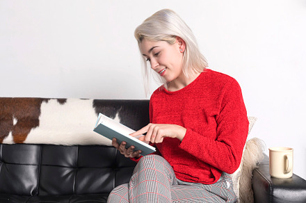 Happy young woman reading and pointing a book, a Person Photo by 2Design