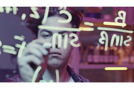 Young man solves mathematical, a School & Education Photo by Media Whale Stock