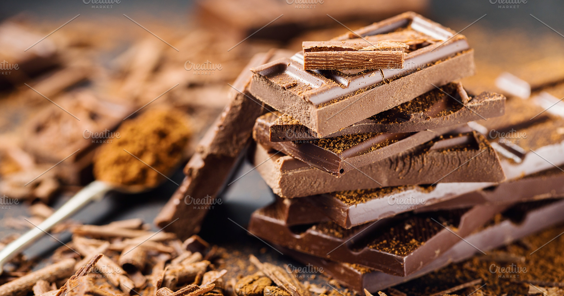 Pile of broken dark chocolate on tab, a Food & Drink Photo by Valeria Art
