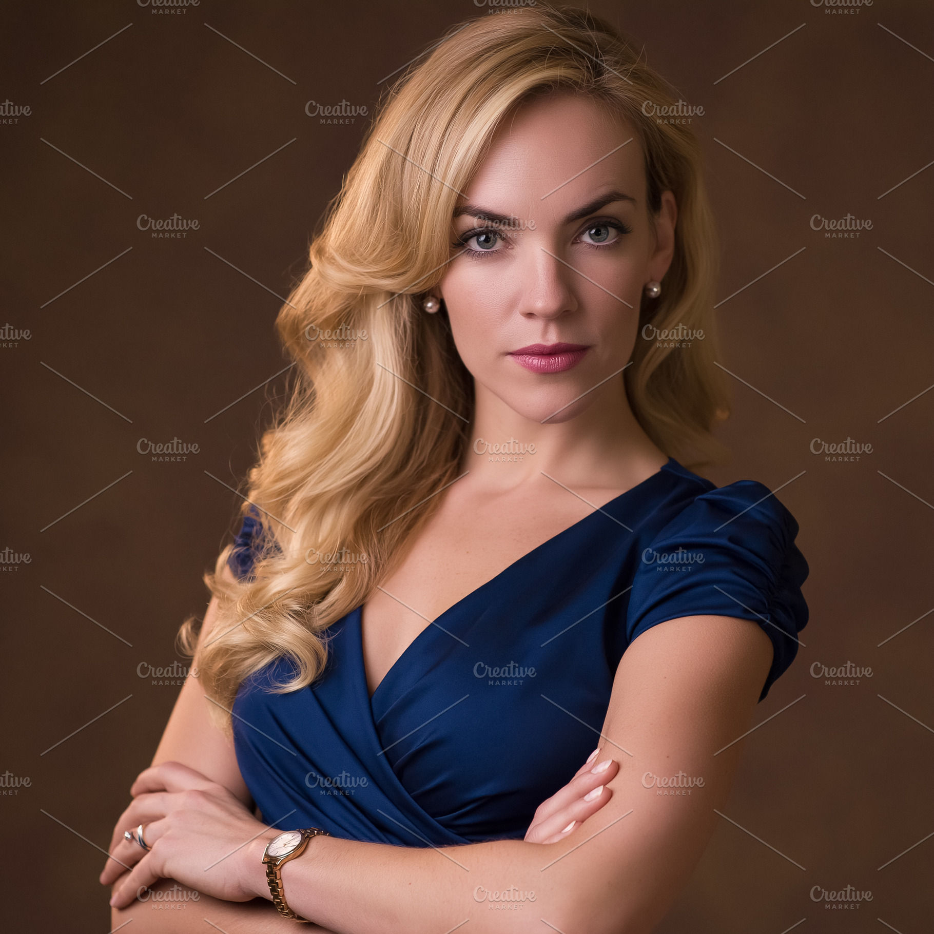 Confident blonde woman in blue dress with arms crossed, portrayi, a Person Photo by Studio ANNA