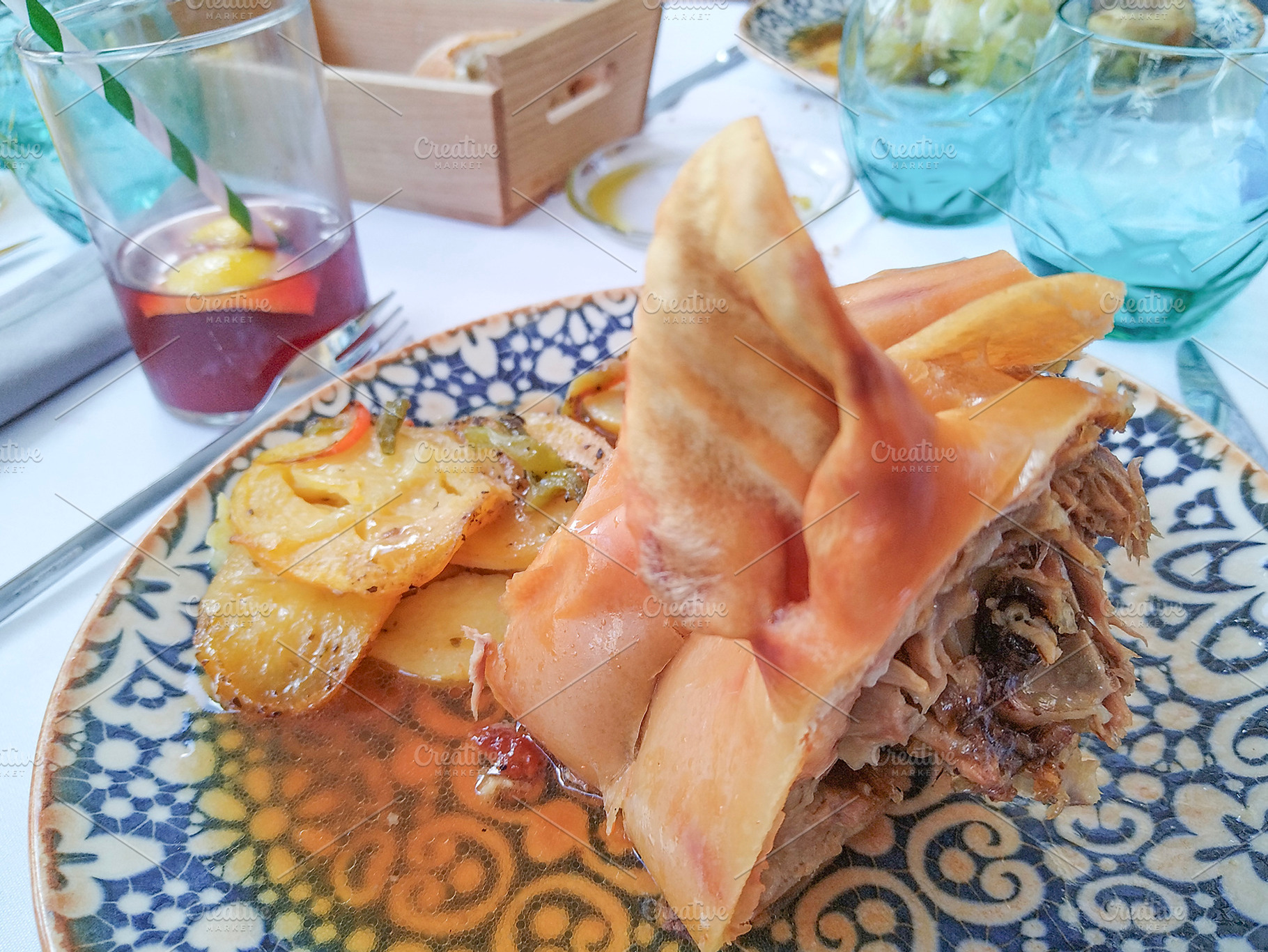 Roasted pork with crispy skin on traditional ceramic plate, a Food & Drink Photo by DanFLCreativo