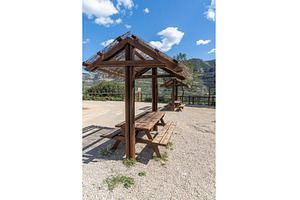 Empty gray wooden table on the green, a Food & Drink Photo by Illustrations&photos