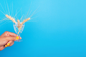 Female hand with yellow nails holding a crystal glass with wheat, a Food & Drink Photo by Ales Munt