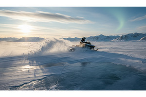 Snowmobiler driving fast on a snow, a Sports & Recreation Photo by Igor Tichonow