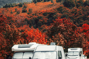 Camper vans in autumn mountains, a Transportation Photo by SkyNext
