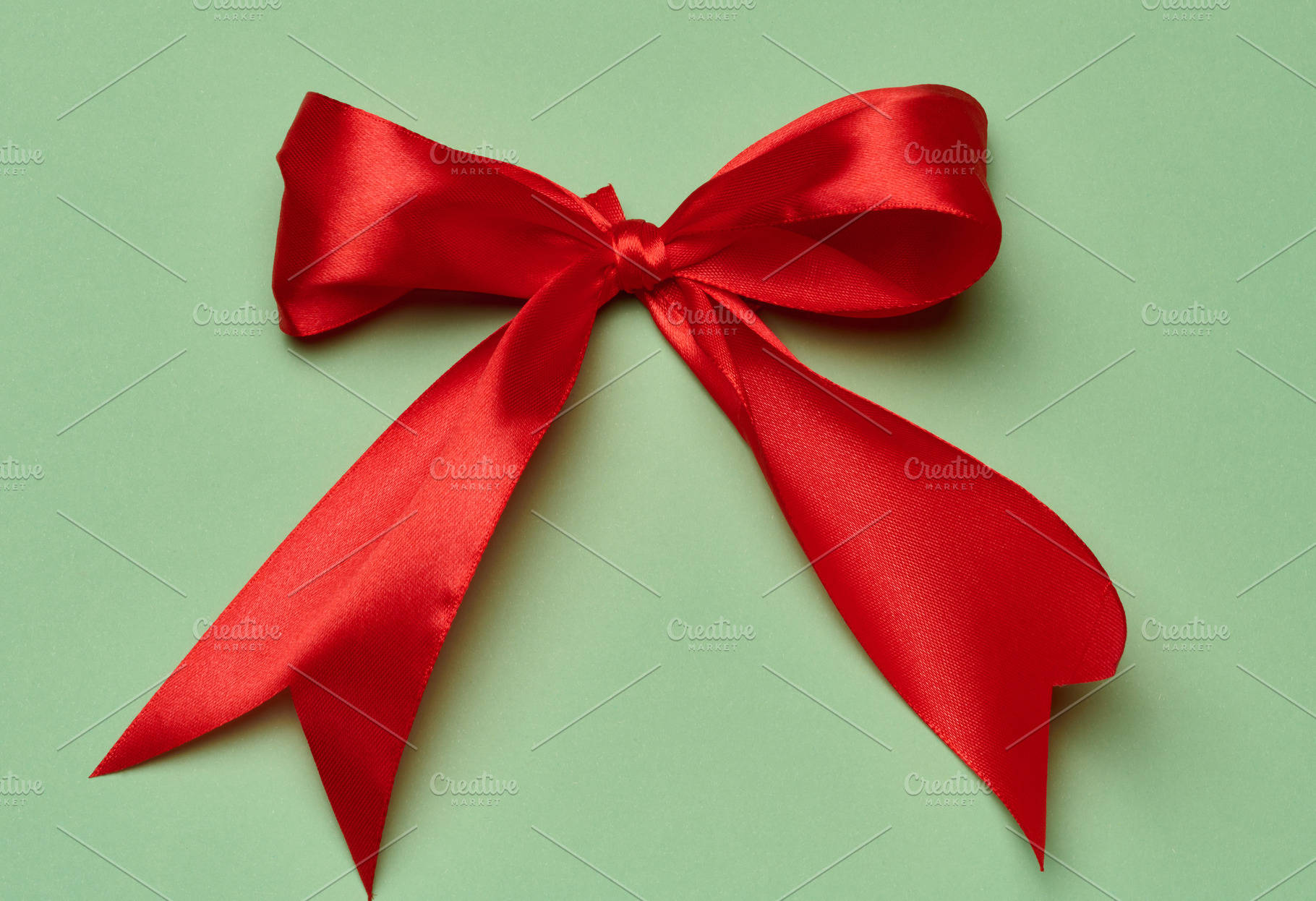 A lush red satin bow made from a wide ribbon in the center of th, a Holiday Photo by ndanko