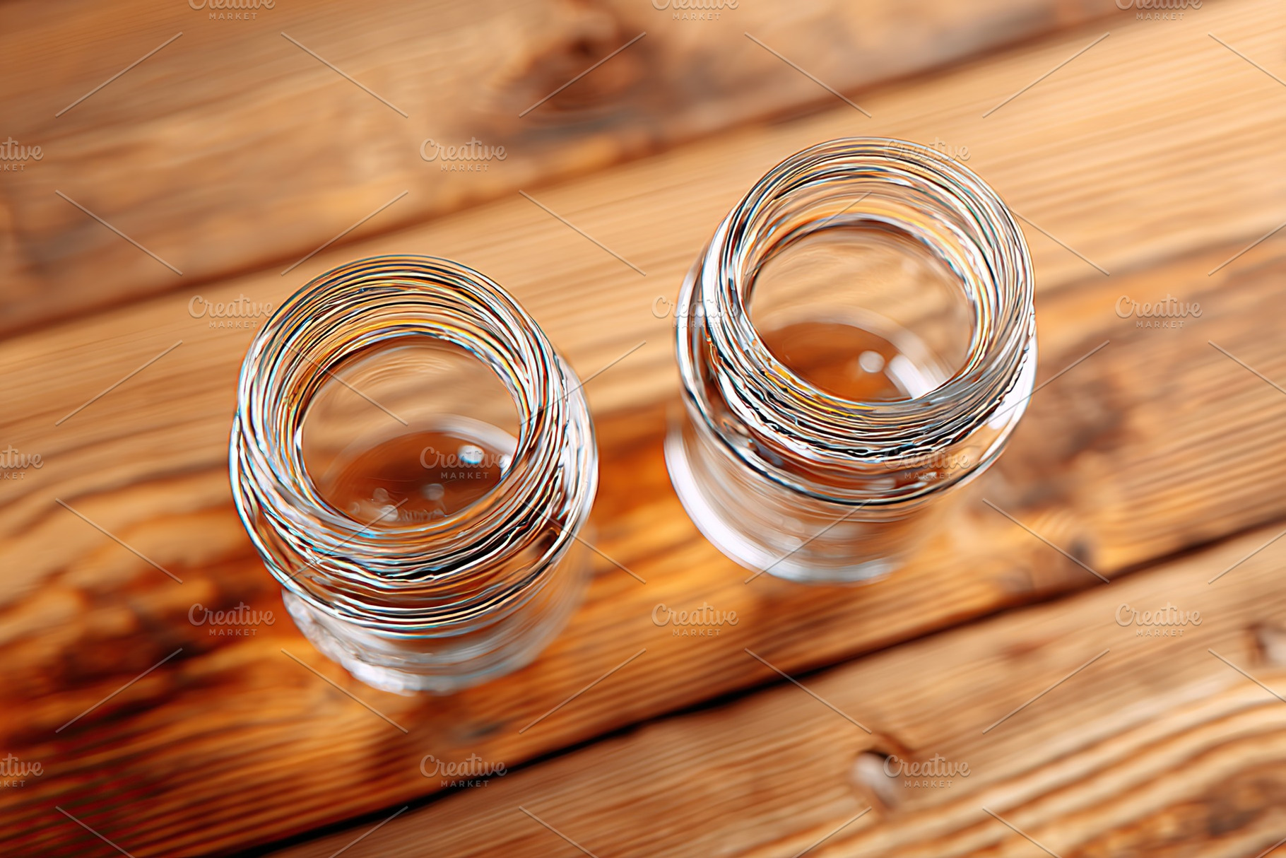Empty glass bottles positioned on a wooden table with a simple, rustic aestheti, a Photo by AlyaAnd
