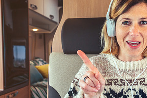 Woman talking looking at camera from her campervan, a Person Photo by davidpereiras