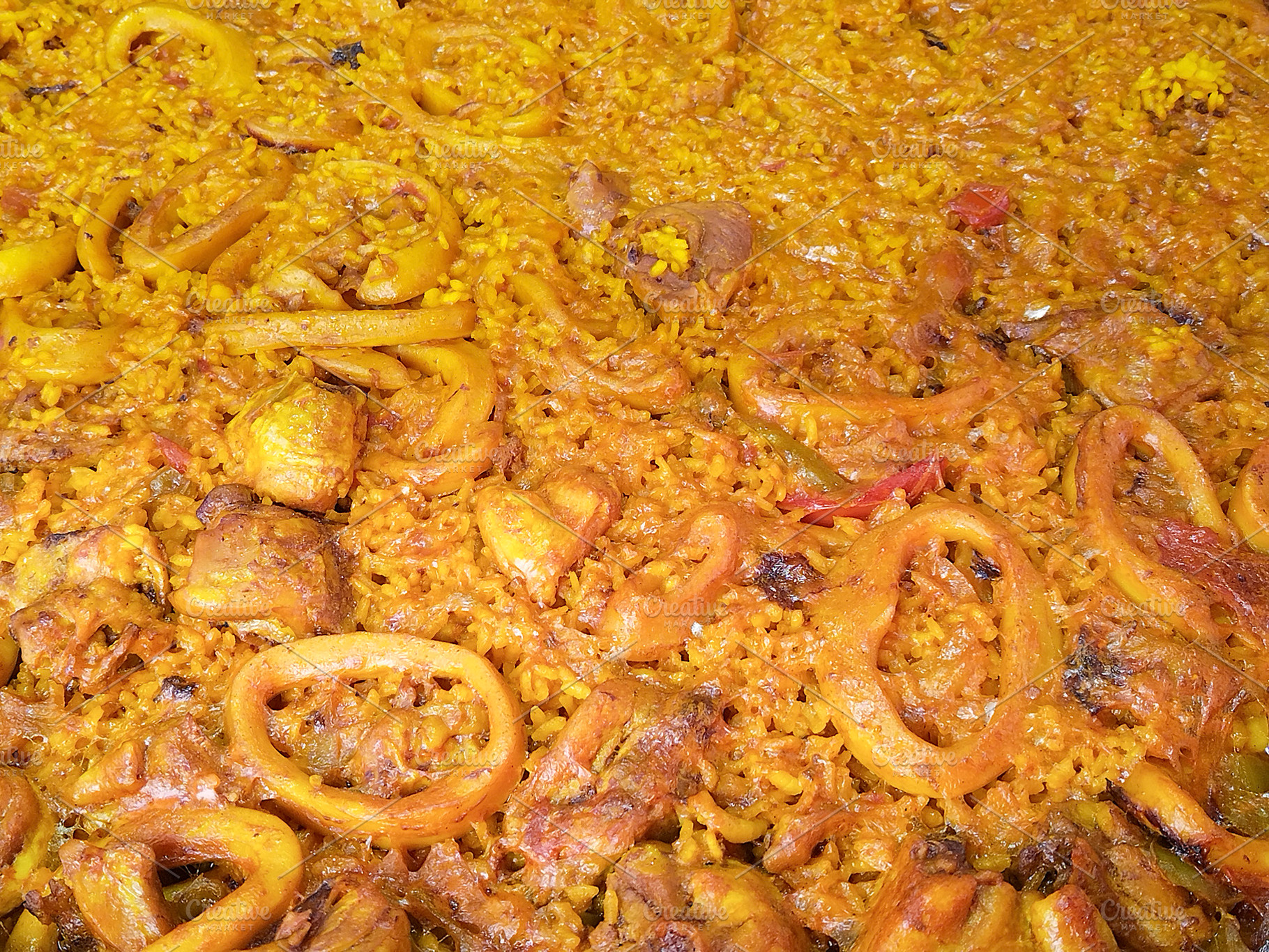 Seafood paella with squid and rice close-up, a Food & Drink Photo by DanFLCreativo