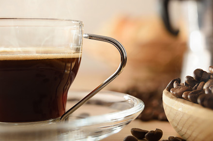 Glass cup of hot coffee and beans close up, a Food & Drink Photo by Davizro's Market