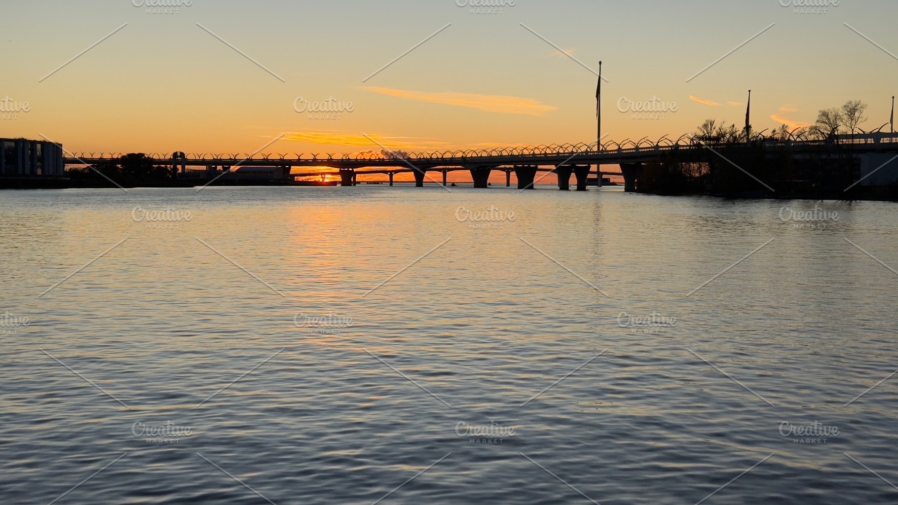 A serene river scene at sunset, featuring a bridge in the background and colorf, a Nature Photo by Textures & Backgrounds