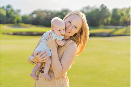 Mother and newborn baby on a meadow