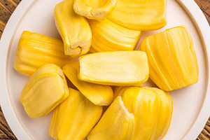 Sweet, golden yellow jackfruit pods (bulbs) served on a white pl, a Photo by composter-box@mail.ru