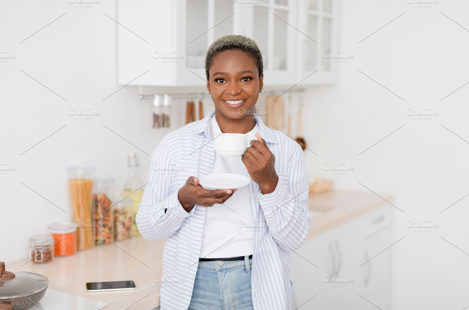 Cheerful pretty millennial black female in casual clothes drinking her favorite, a Person Photo by Prostock-Studio