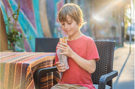 Boy eating street food in Istanbul, a Food & Drink Photo by Elizaveta Galitskaya
