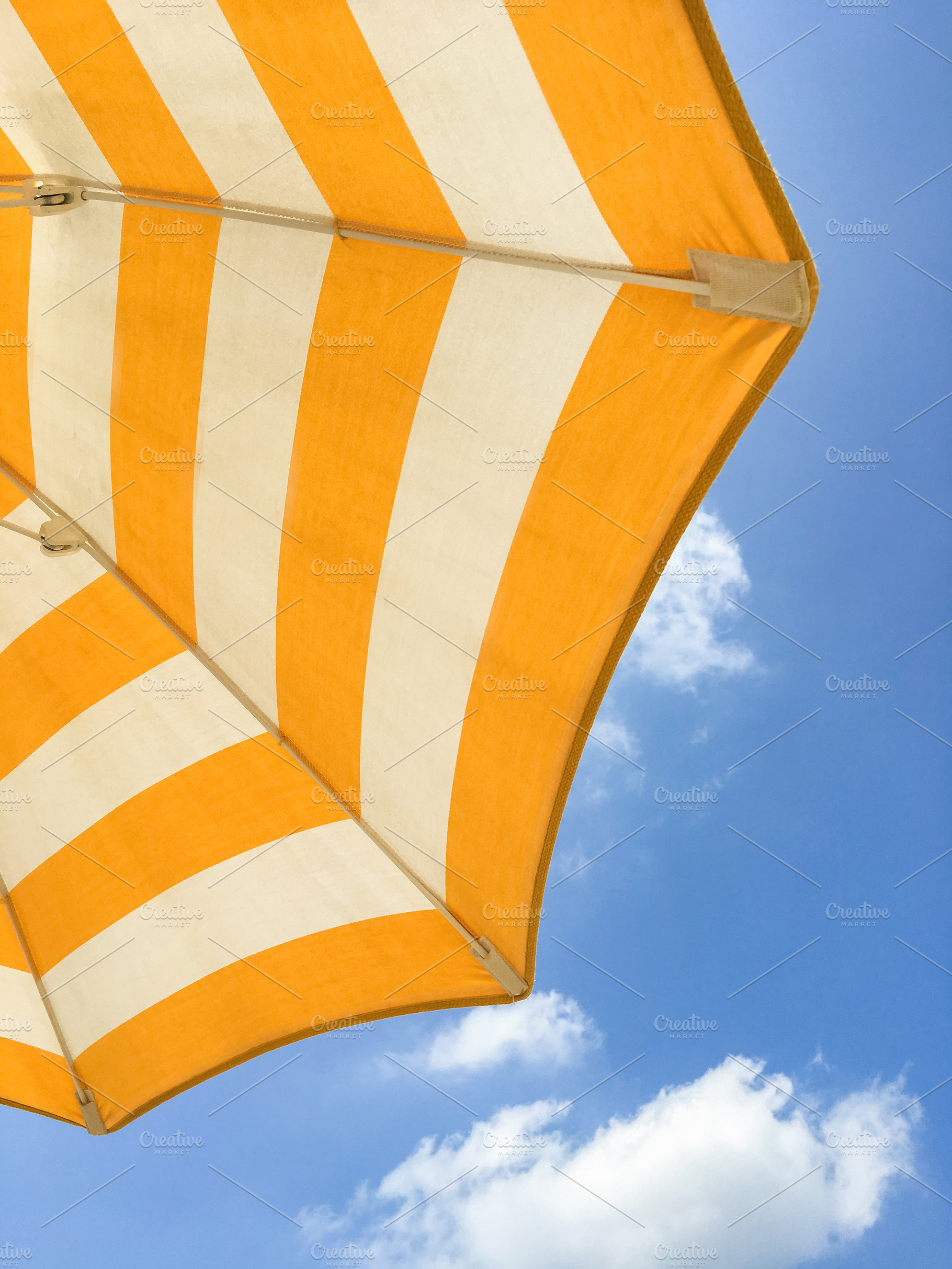 Yellow umbrella on the beach, an Abstract Photo by KYNA STUDIO