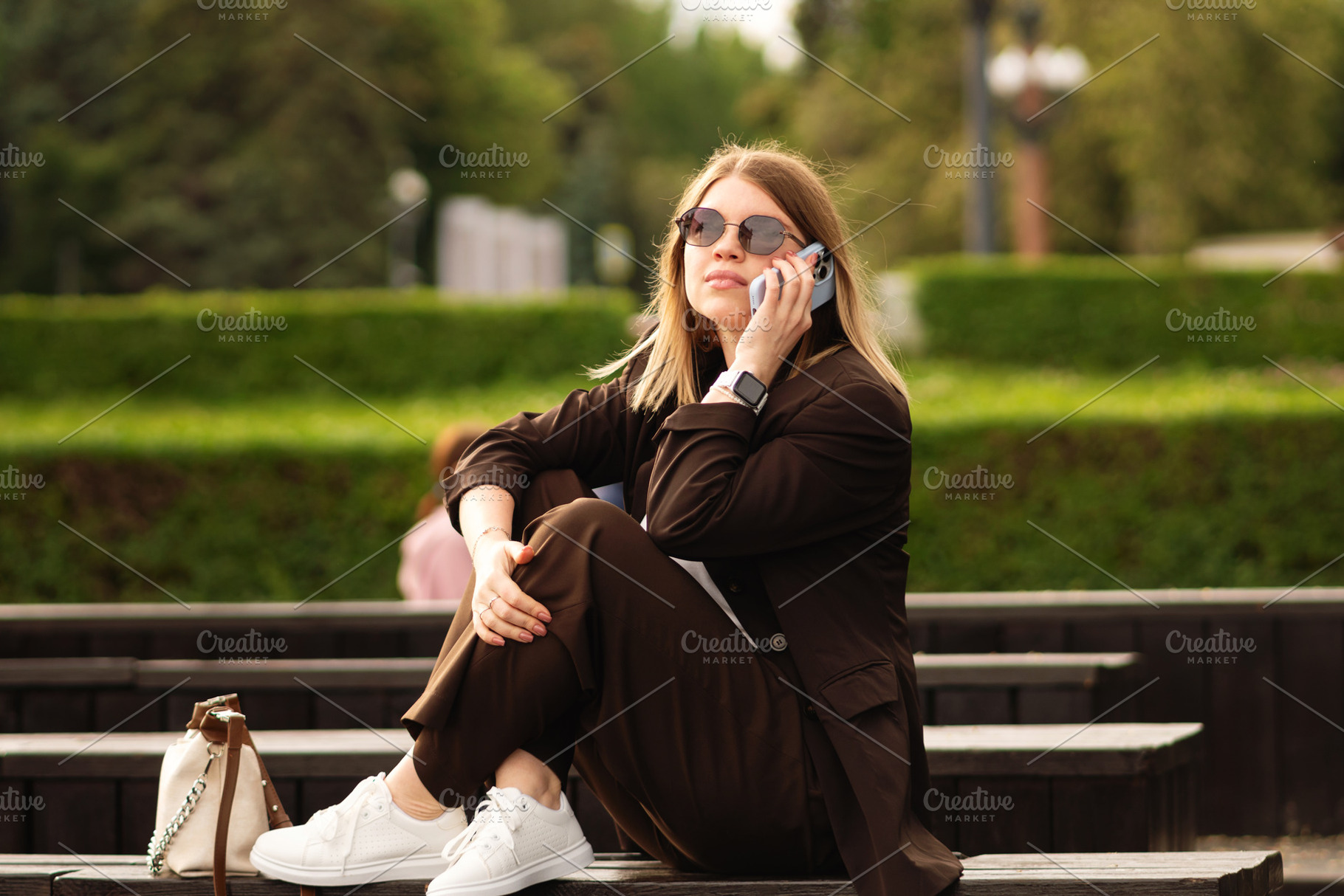 Young woman in brown suit sitting, a Person Photo by Elena Vagengeim