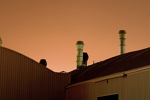 Industrial Roof Vents Against Orange Night Sky, an Industrial Photo by Davizro's Market