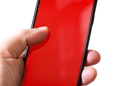 Hand holding a smartphone with blank red screen. Isolated on whi, a Technology Photo by GoodGoods