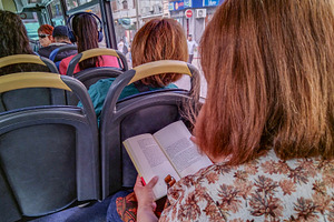 View from inside a bus looking over a passenger's shoulder, a Transportation Photo by DanFLCreativo