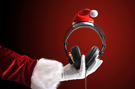 Santa Claus holding headphones on red isolated background, a Sports & Recreation Photo by Davizro's Market