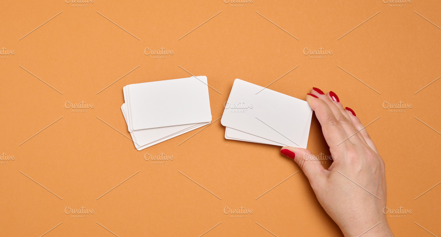 A woman's hand holds a stack of blank white business cards again, a Business Photo by ndanko