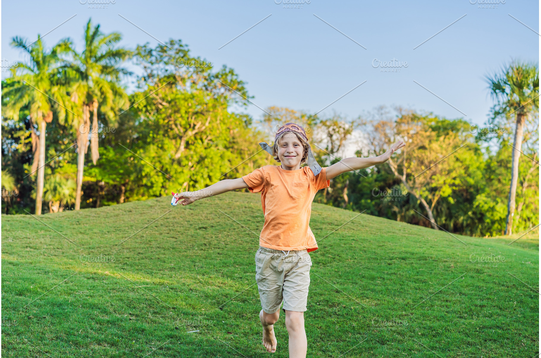 Boy wearing a pilot hat running, a Nature Photo by Elizaveta Galitskaya