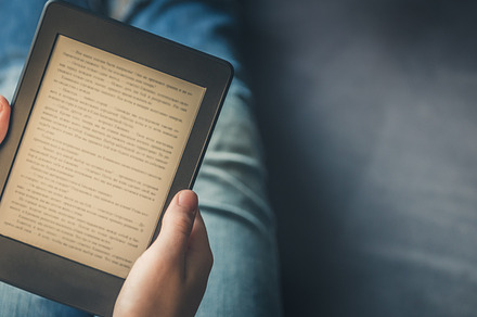 Girl is reading ebook on digital tablet device featuring ebook, man, and, a Technology Photo by MAnuta