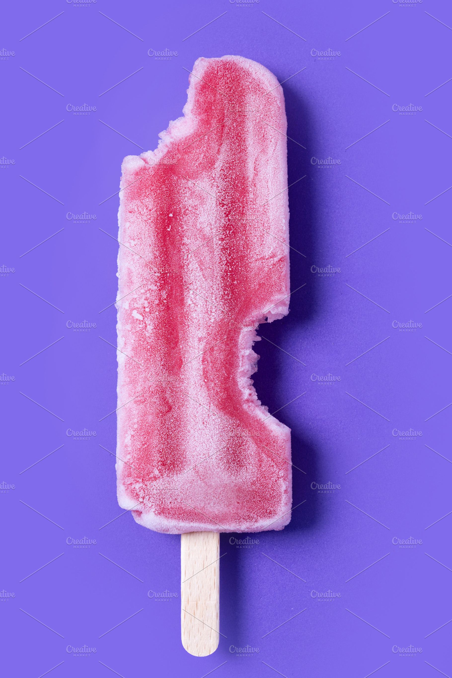 Red strawberry popsicles on purple background. Close up, a Food & Drink Photo by etorres69