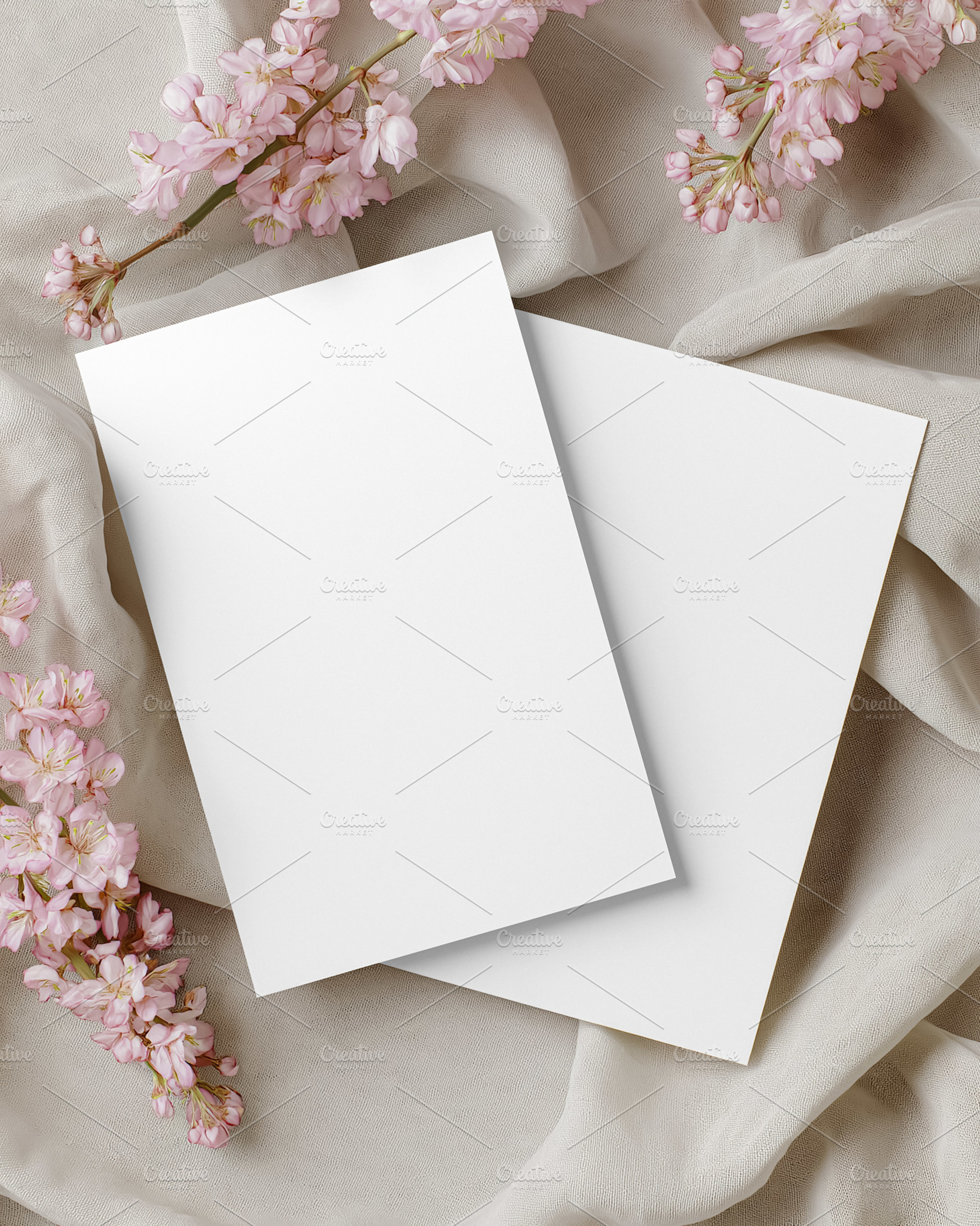 Blank paper cards mockup with pink cherry blossoms on soft draped silk fabric c, a Holiday Photo by Studio ANNA