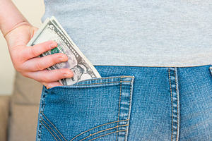 Woman’s hand is putting money in pocket, a Business Photo by Vapi