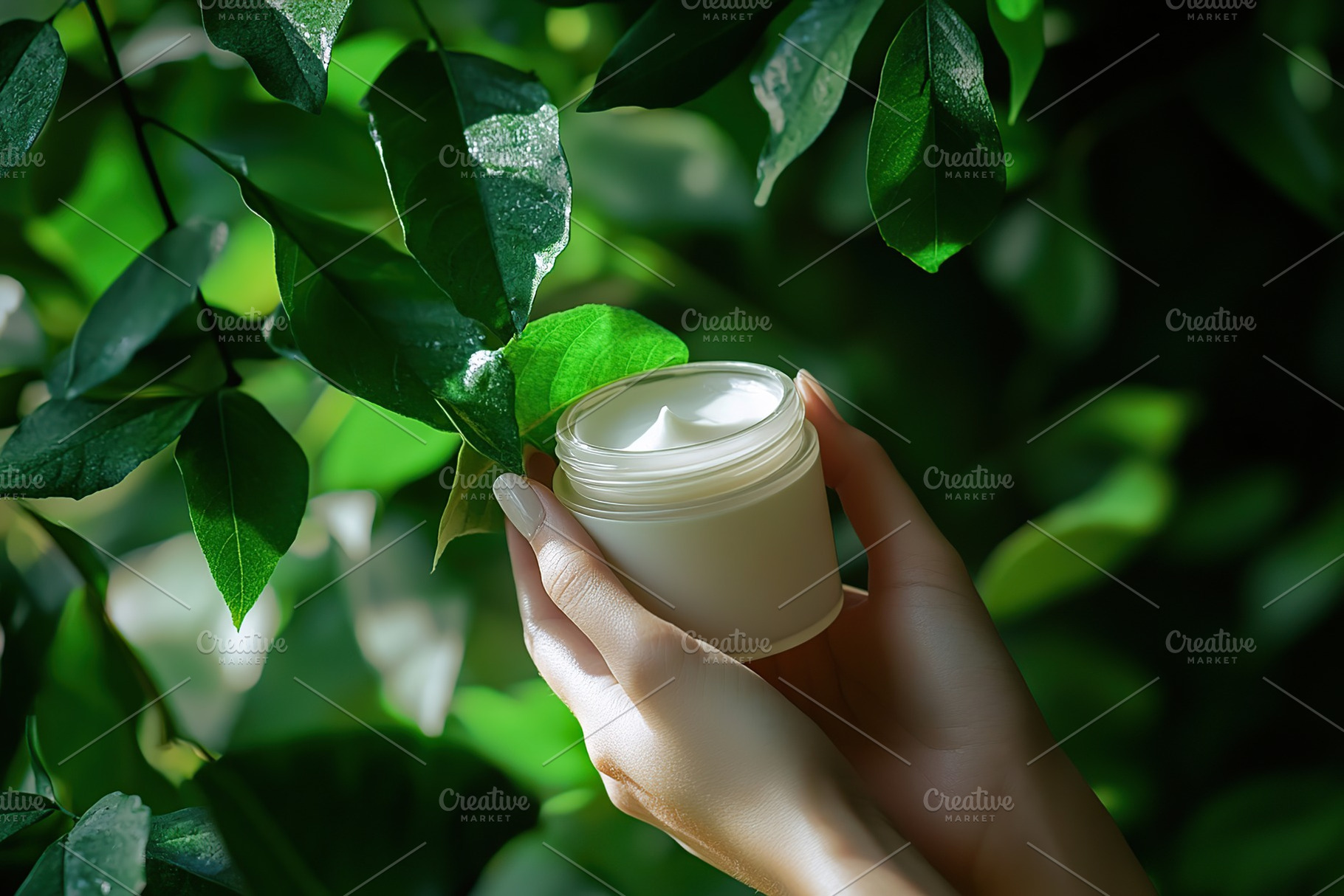 Female model hand holding cosmetic jar on green leaves background, a Health & Medical Photo by AlyaAnd