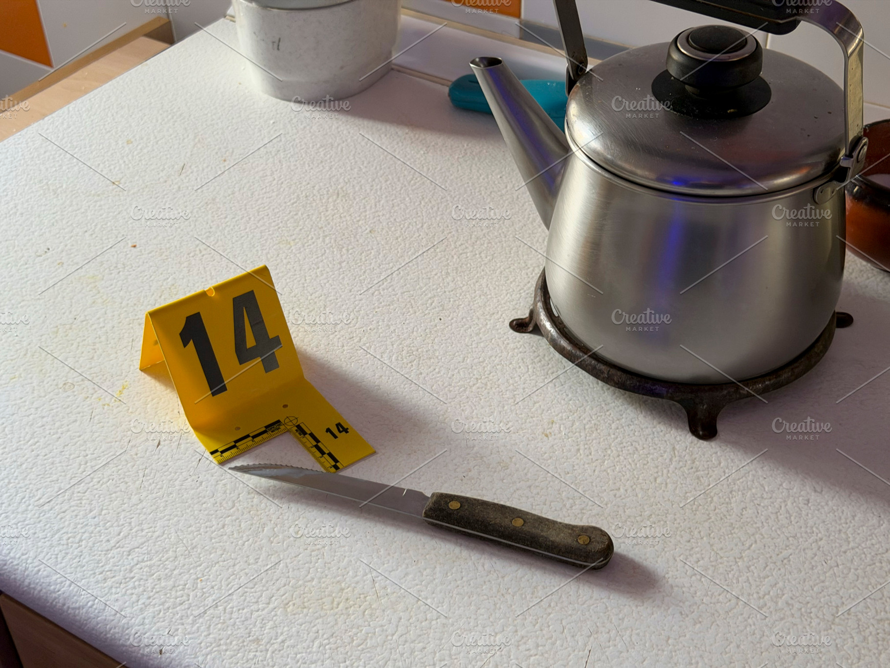 Knife with evidence marker at a crime scene, an Industrial Photo by karrastock
