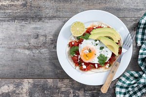 Huevos Rancheros on wooden table., a Food & Drink Photo by etorres69