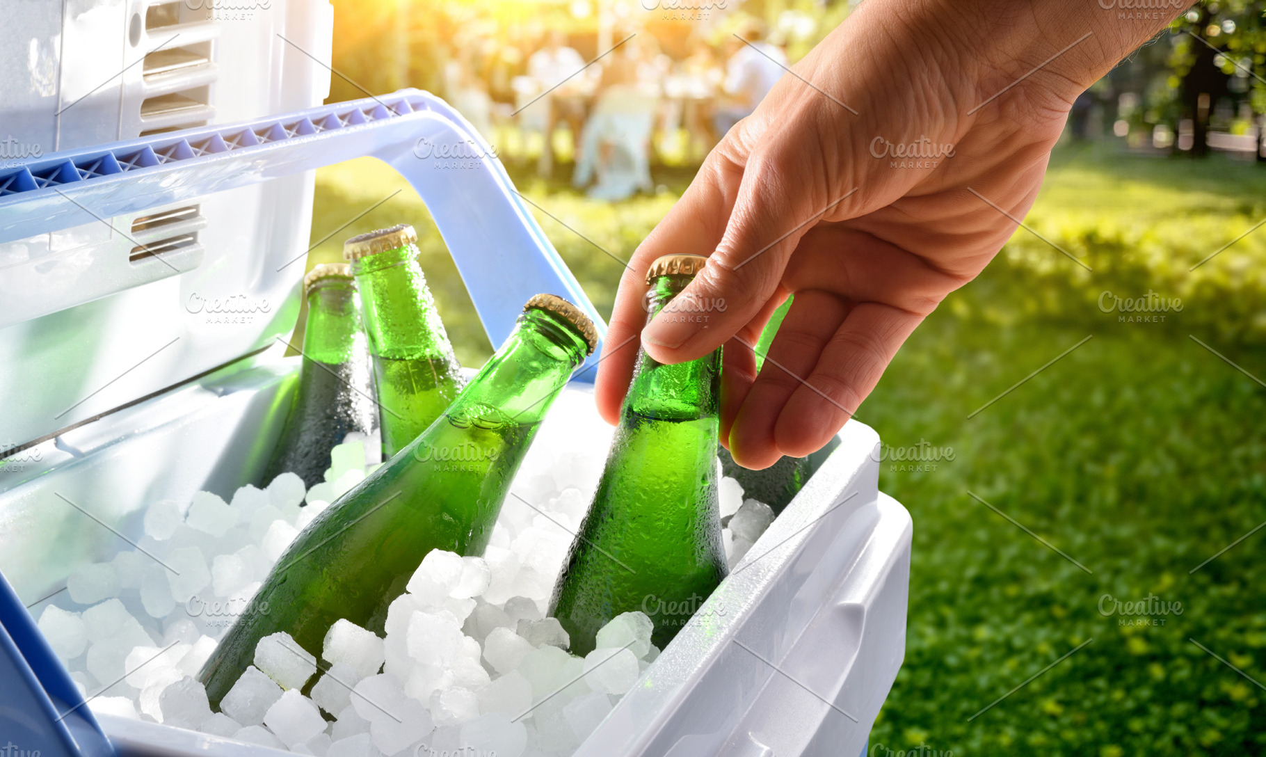 Hand Taking Cold Bottles From Cooler, a Food & Drink Photo by Davizro's Market