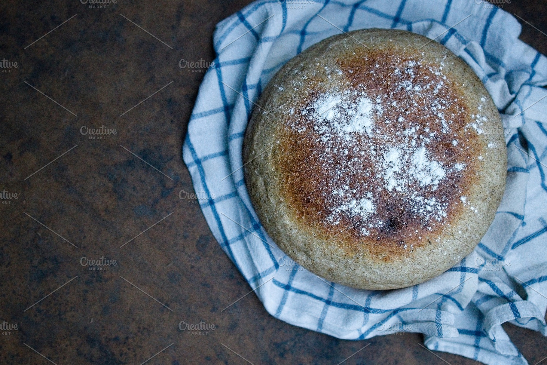 Home cooked round bread, on a dark background. View from above, a Food & Drink Photo by TanaCh