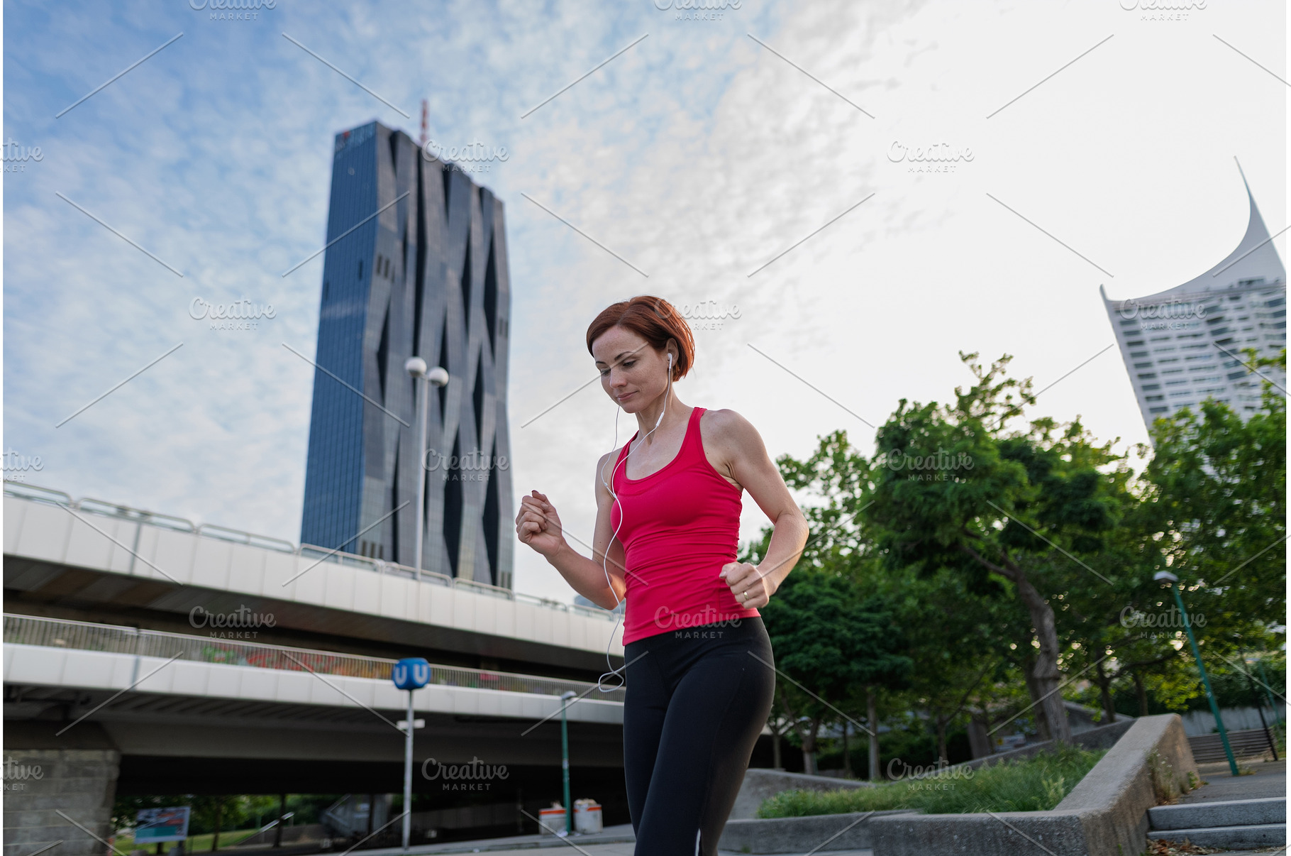 sporty woman running across a city, a Person Photo by HalfPoint