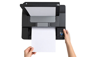 Hand placing a paper document into a print, a Technology Photo by DanFLCreativo