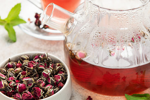 Dried rose buds brewing herbal tea infusion, a Food & Drink Photo by Olena Rudo