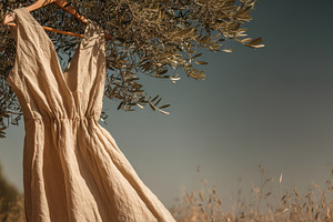 Hanging linen dress on olive tree, a Beauty & Fashion Photo by Virgo Studio