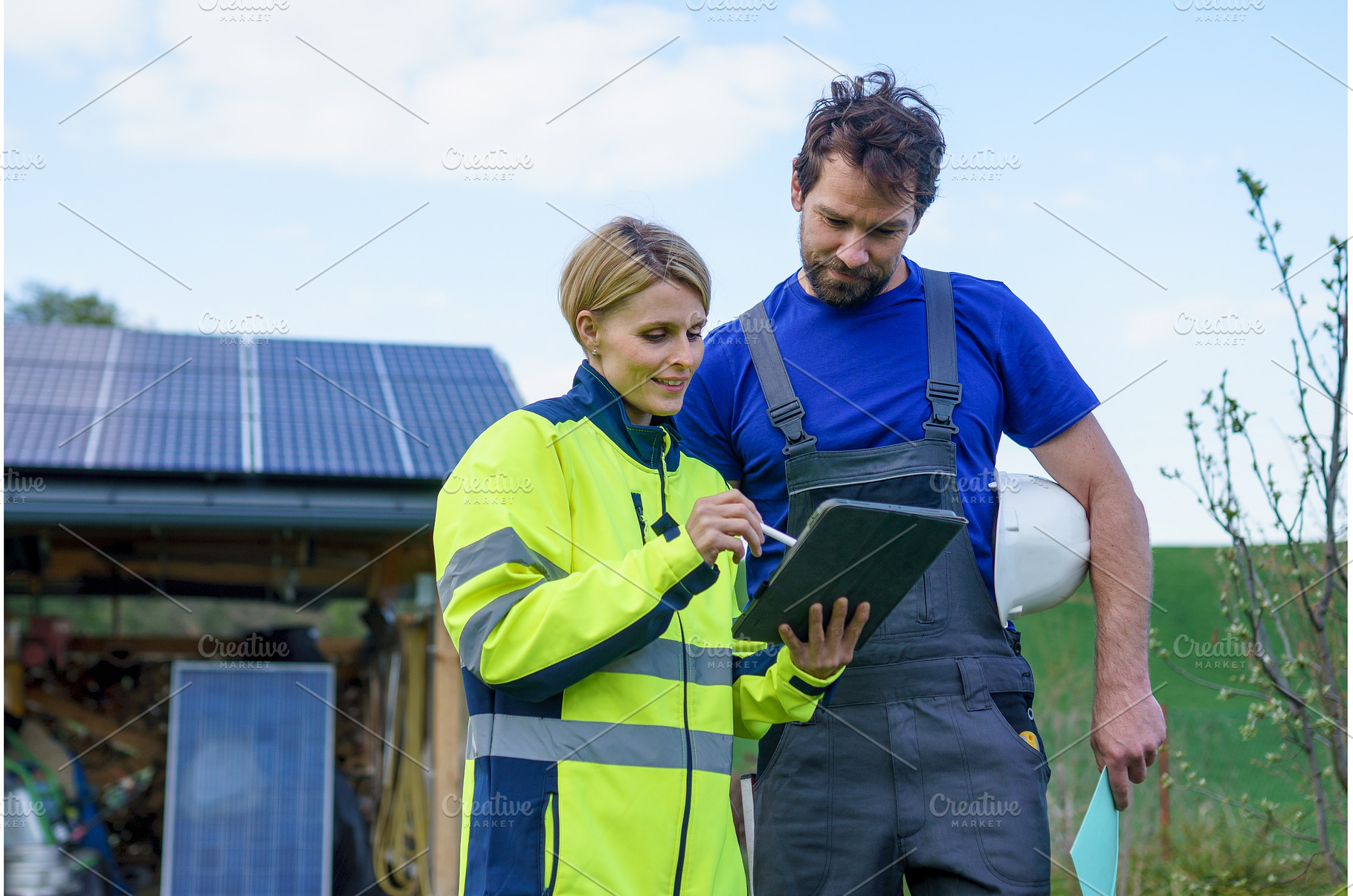 Man and woman solar installers, an Industrial Photo by HalfPoint