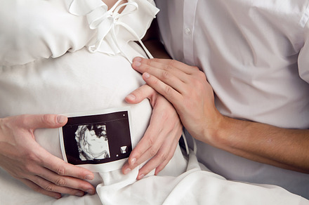 Pregnant girl holding stock photo containing medical and family, a Person Photo by SaulichPhoto