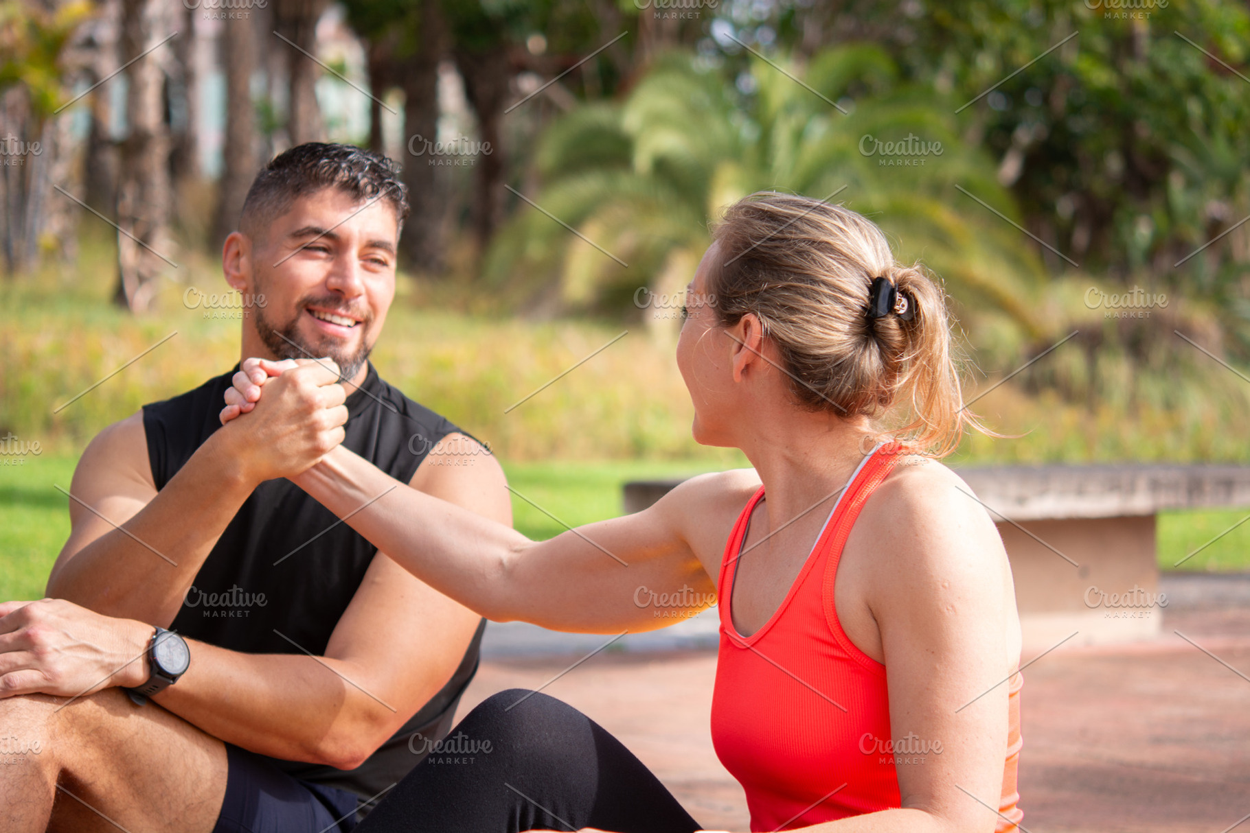 Happy fitness partners resting together after outdoor workout in park, a Person Photo by etorres69