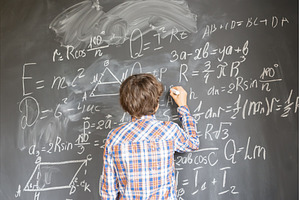 Boy writting on black board, a School & Education Photo by Neirfy