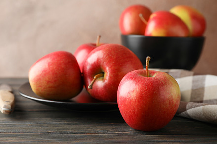 Composition with apples, plate and kitchen towel on wooden backg, a Food & Drink Photo by AtlasStudio
