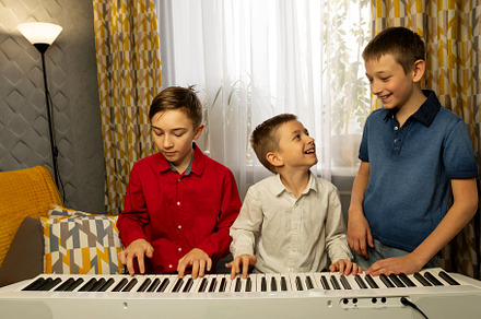 Boys playing the piano and enjoying, a School & Education Photo by Elena Vagengeim