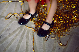 children feet with black shoes and